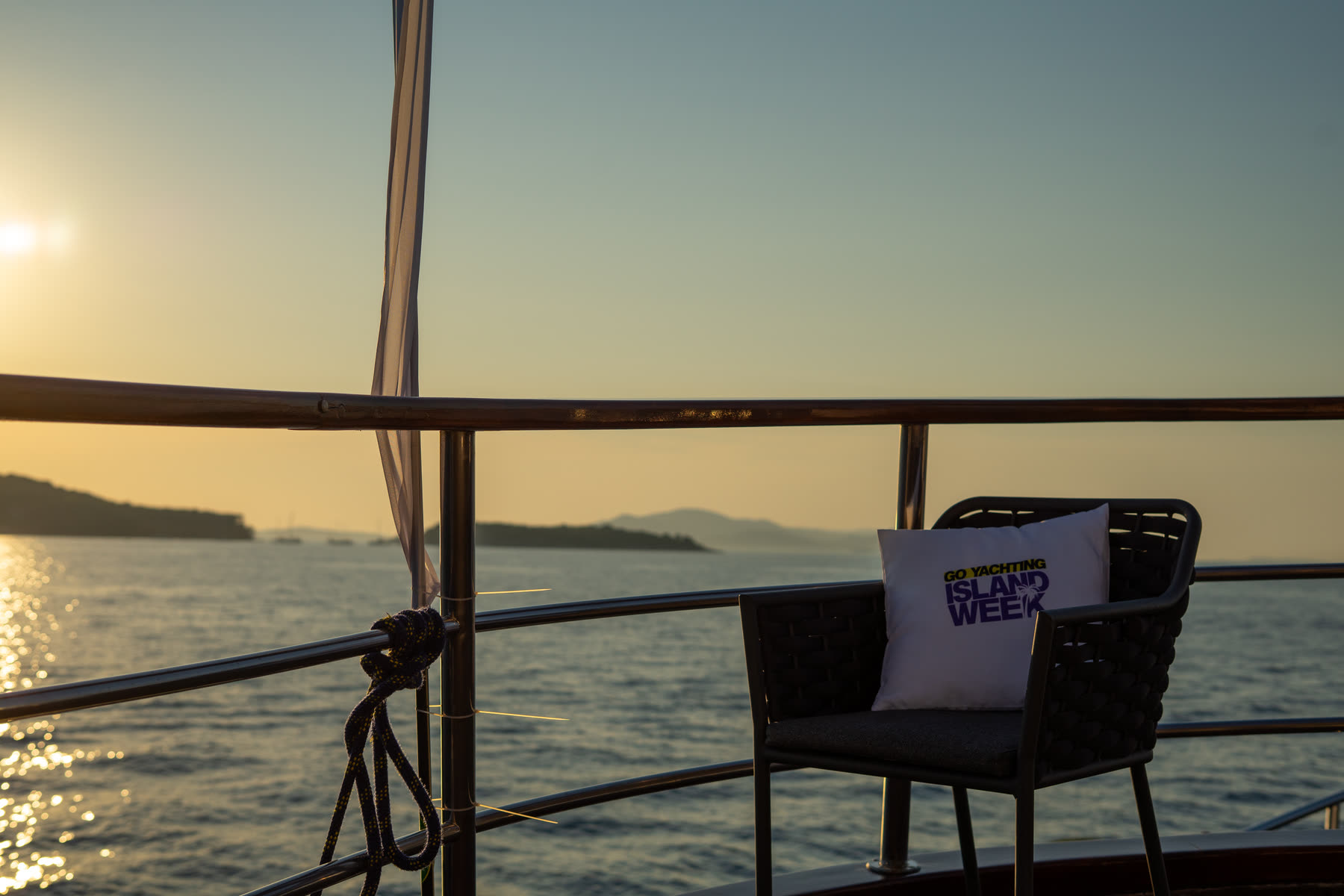 An empty chair on deck at anchor